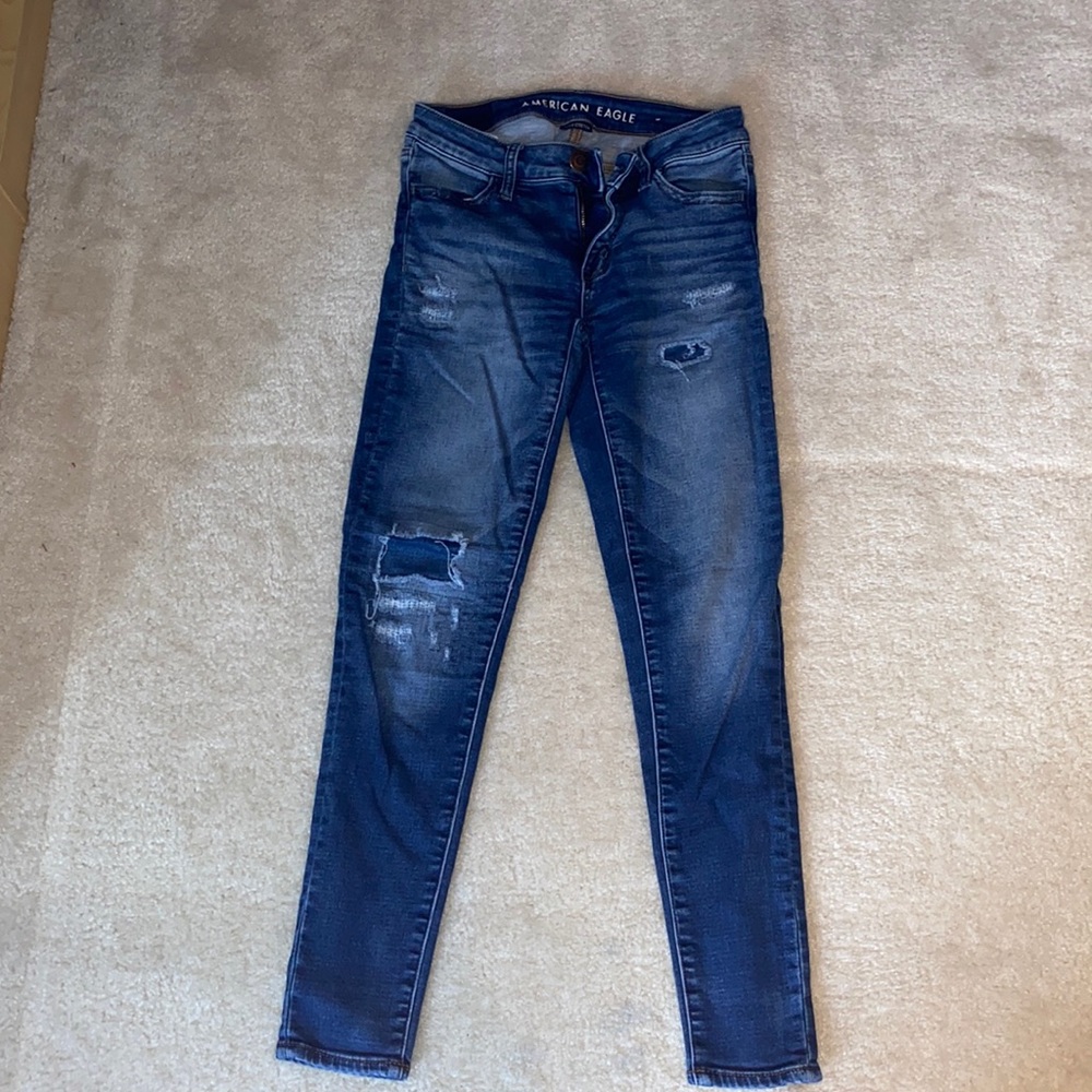 American Eagle super stretch skinny jeans with distressed patches.